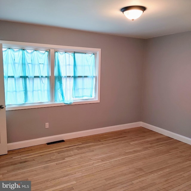 unfurnished room with light hardwood / wood-style floors