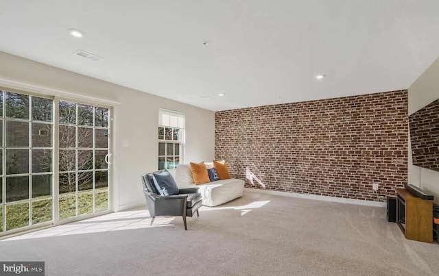 unfurnished room with light carpet and brick wall