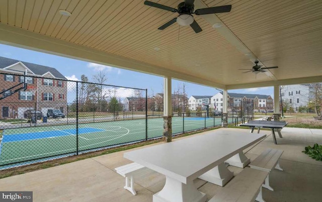 view of sport court with a wealth of natural light and tennis court