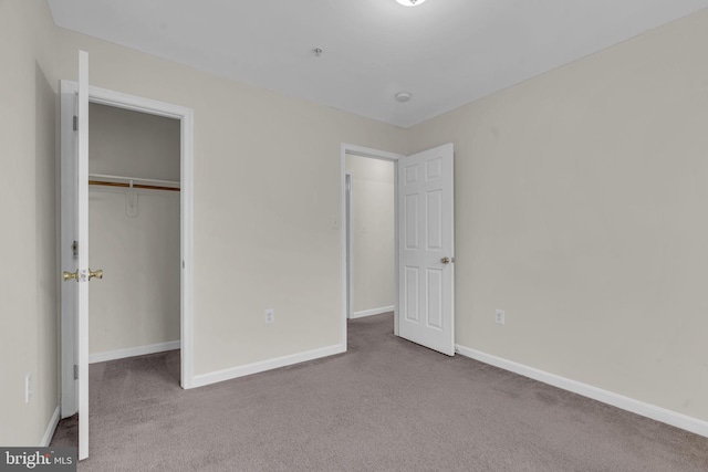 unfurnished bedroom with carpet floors and a closet