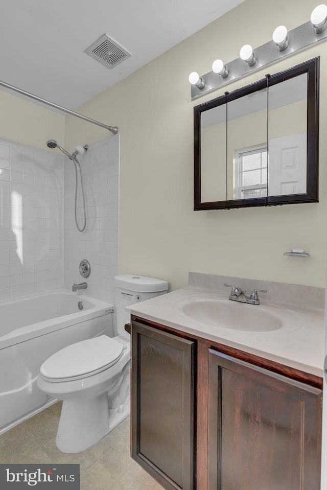 full bathroom with vanity, toilet, and tiled shower / bath