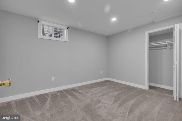 unfurnished bedroom featuring carpet floors and a closet