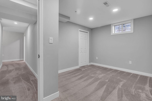 basement featuring light colored carpet