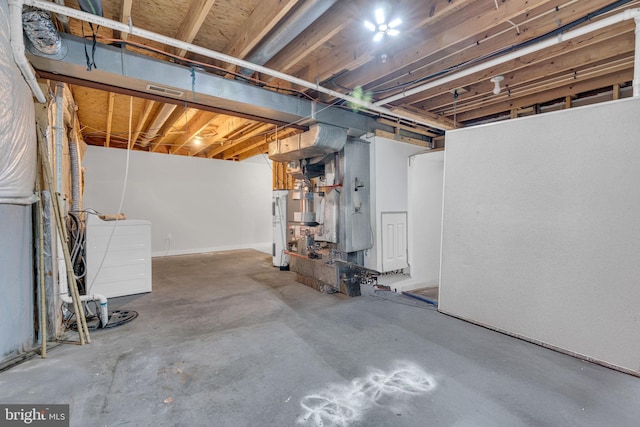 basement with electric water heater and washer / clothes dryer