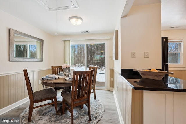 dining room with hardwood / wood-style floors and a wealth of natural light