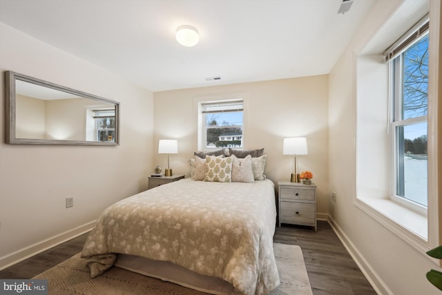 bedroom with dark hardwood / wood-style flooring