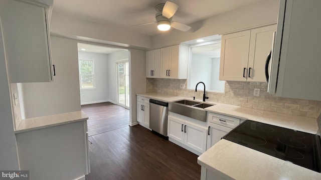 kitchen featuring dark hardwood / wood-style flooring, tasteful backsplash, sink, dishwasher, and white cabinetry