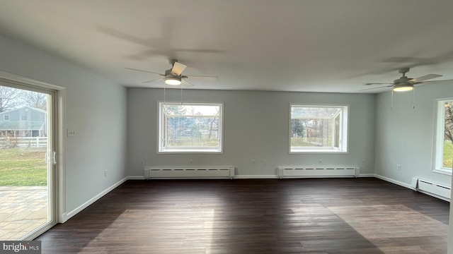 empty room with plenty of natural light and a baseboard radiator