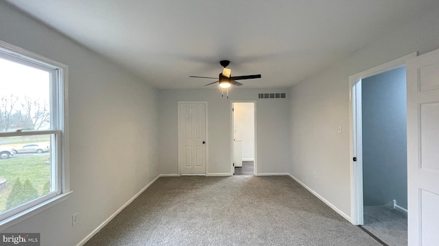 unfurnished room with ceiling fan and carpet floors