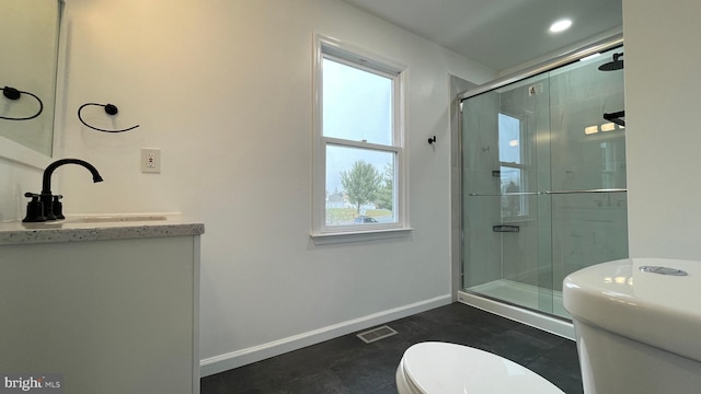 bathroom with tile patterned floors, vanity, toilet, and a shower with shower door