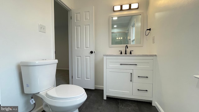 bathroom with vanity, toilet, and an enclosed shower