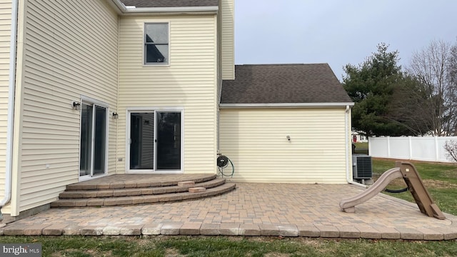 rear view of property with cooling unit and a patio area