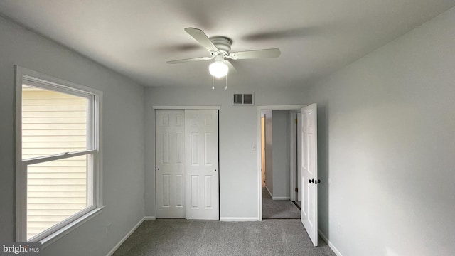 unfurnished bedroom featuring ceiling fan, a closet, and carpet floors