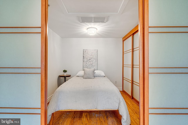 bedroom with visible vents and wood finished floors