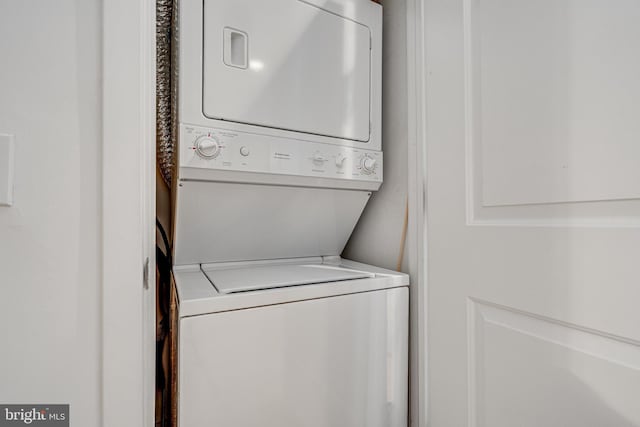 laundry room featuring laundry area and stacked washer and clothes dryer