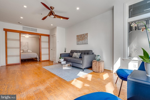 living area featuring recessed lighting, visible vents, ceiling fan, and light wood-style flooring