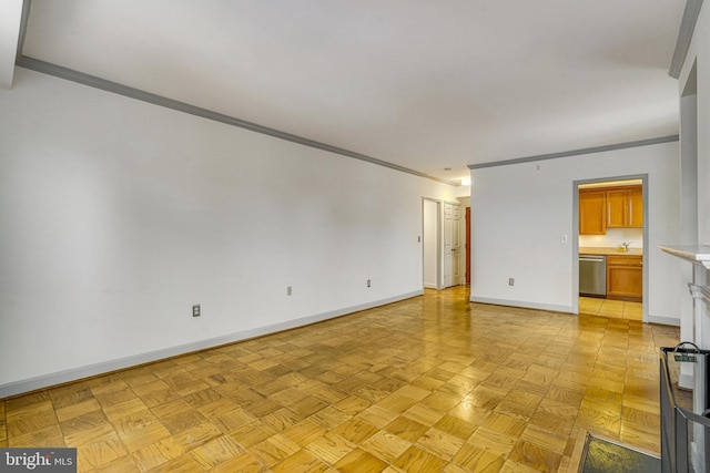 empty room featuring light parquet flooring, crown molding, and sink