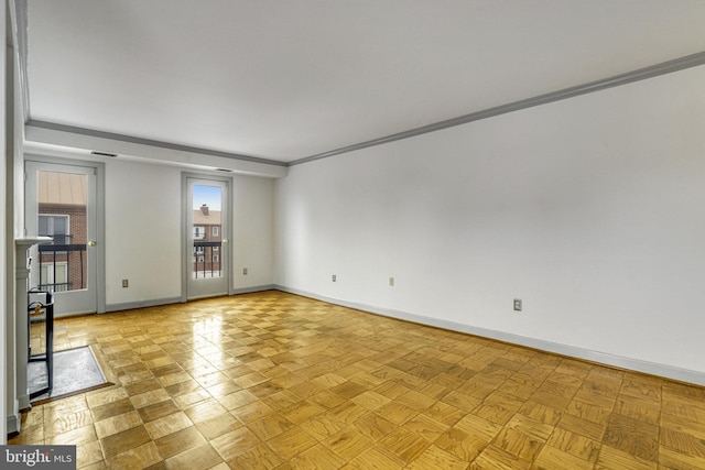 spare room featuring light parquet floors and ornamental molding