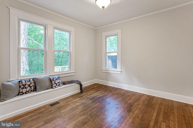 spare room featuring dark hardwood / wood-style flooring and ornamental molding