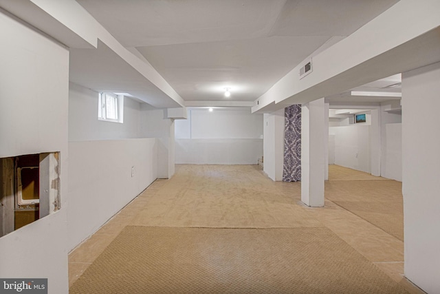 basement featuring light colored carpet