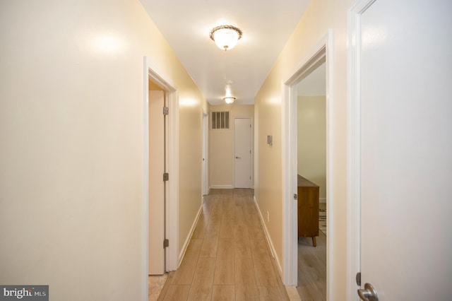 corridor with light hardwood / wood-style flooring