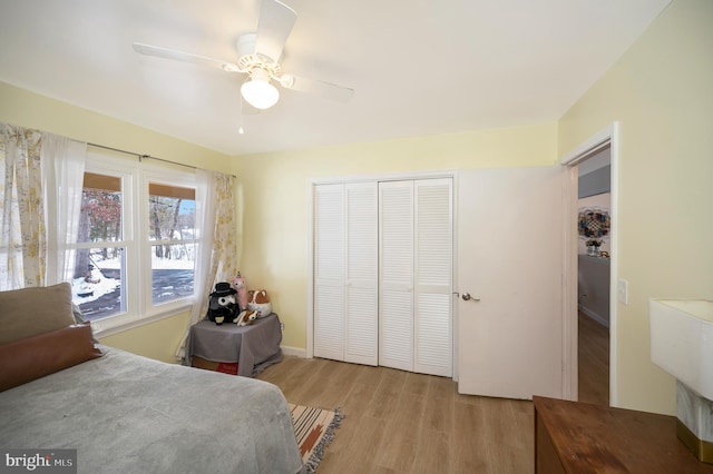 bedroom featuring ceiling fan, a closet, and light hardwood / wood-style flooring