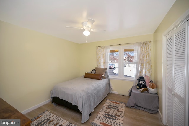 bedroom featuring ceiling fan, light hardwood / wood-style flooring, and a closet