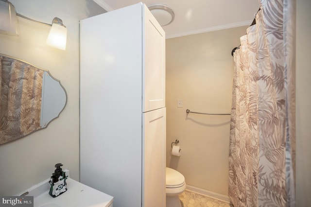 bathroom featuring toilet and crown molding