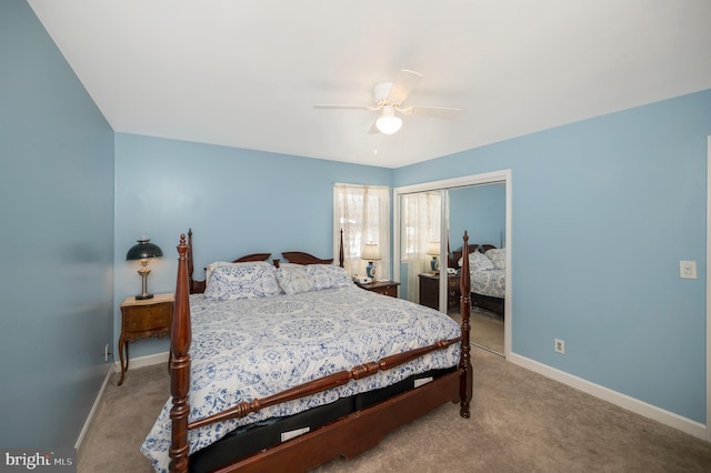 carpeted bedroom with ceiling fan and a closet