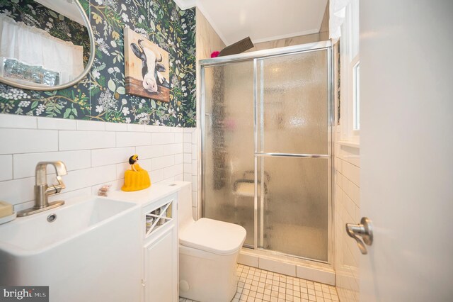 bathroom with sink, toilet, an enclosed shower, and ornamental molding