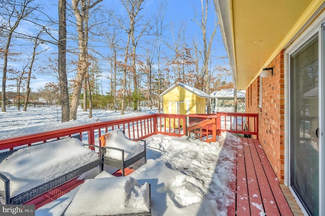 snow covered deck with a storage unit