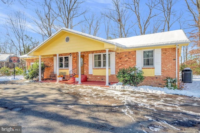 view of front of home with covered porch and central AC