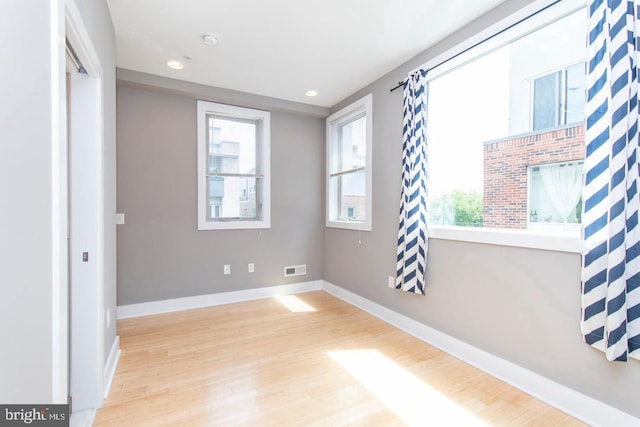 unfurnished room with light wood-type flooring