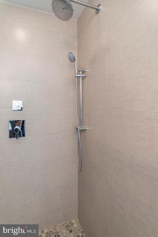 bathroom with tiled shower