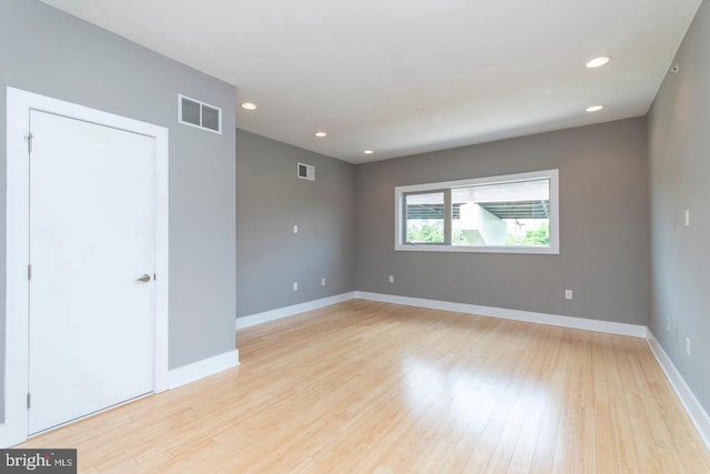 spare room featuring light hardwood / wood-style flooring