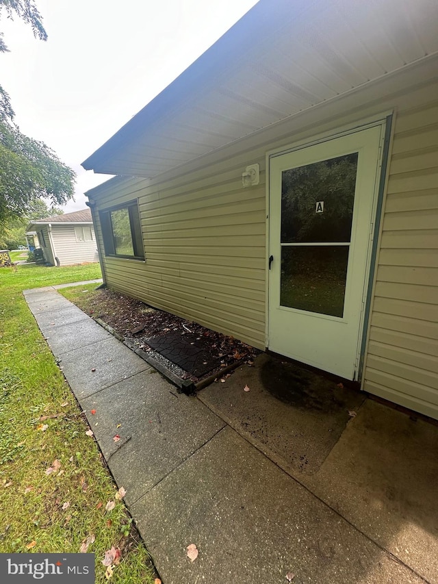 view of exterior entry featuring a patio area