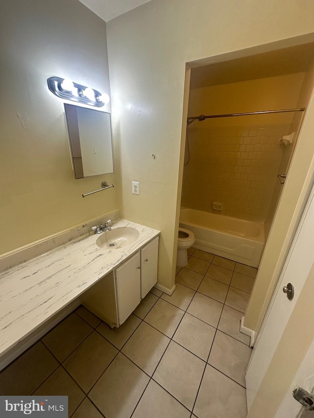 full bathroom with tile patterned flooring, vanity, tiled shower / bath combo, and toilet