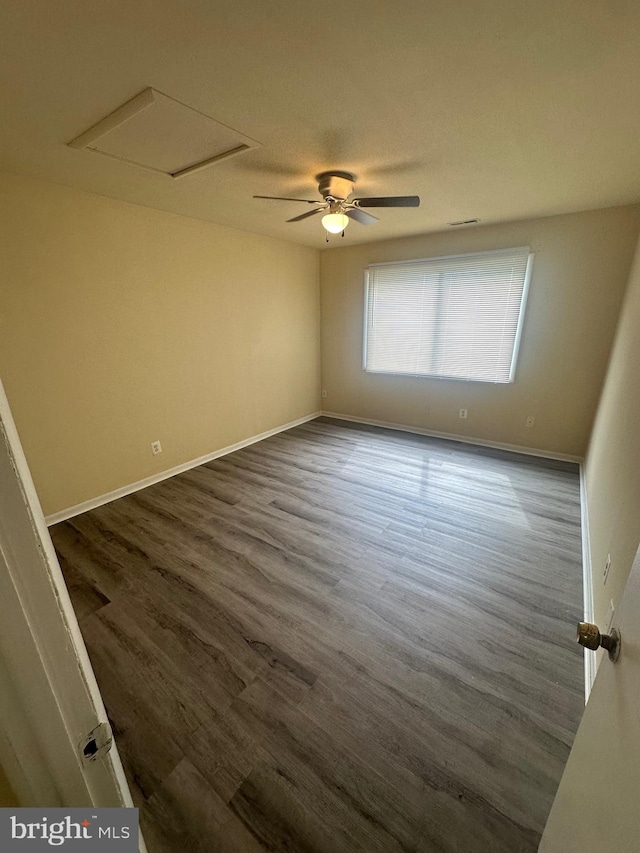 empty room with ceiling fan and dark wood-type flooring