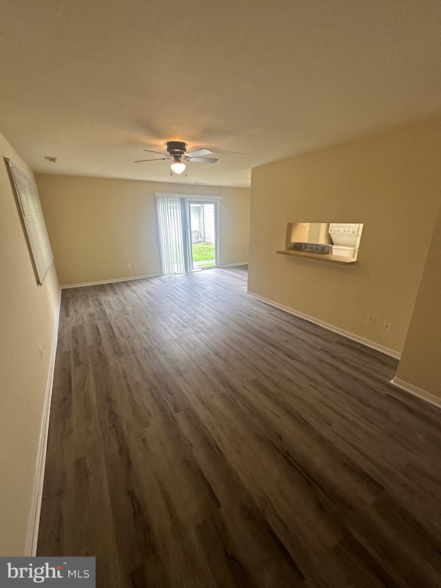 spare room featuring ceiling fan and dark hardwood / wood-style floors