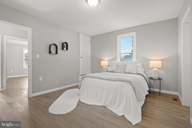 bedroom with wood-type flooring