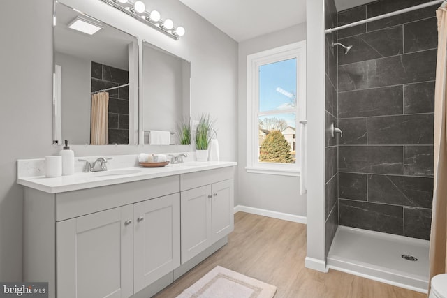 bathroom featuring vanity, hardwood / wood-style flooring, and walk in shower