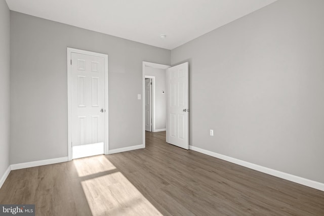 unfurnished bedroom with hardwood / wood-style floors