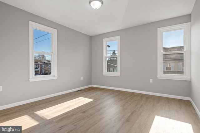 unfurnished room featuring light hardwood / wood-style flooring