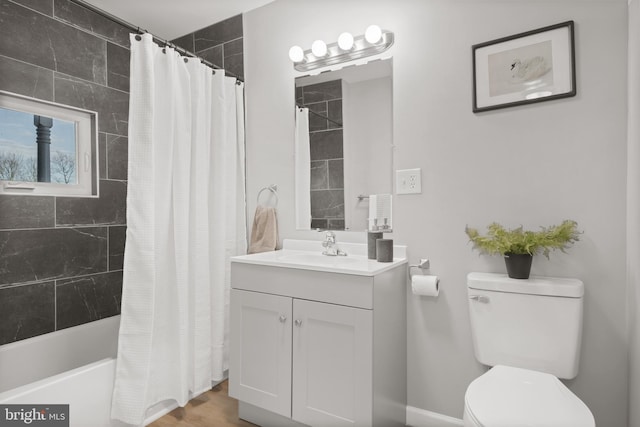 full bathroom with shower / bath combo with shower curtain, vanity, hardwood / wood-style floors, and toilet