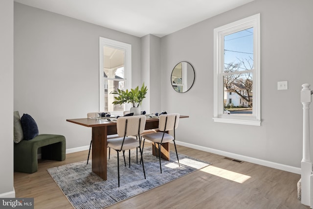 dining space featuring a healthy amount of sunlight and light hardwood / wood-style floors