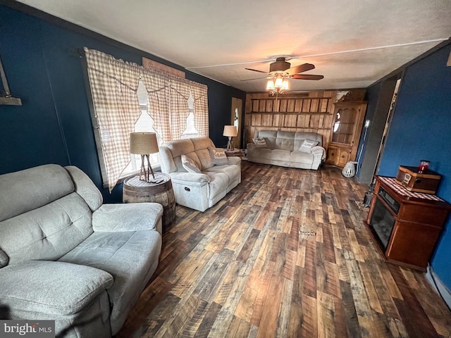 living room with ceiling fan and dark wood-type flooring