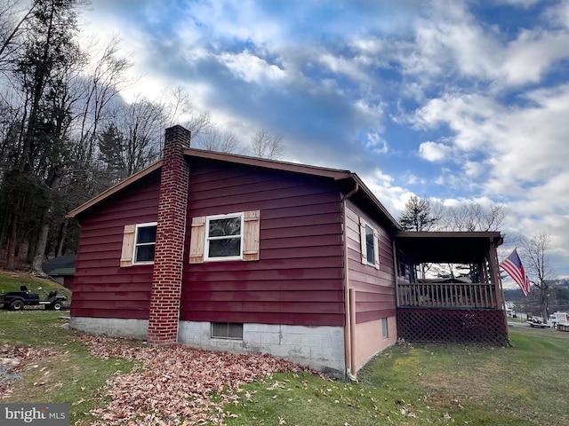 view of side of home featuring a yard