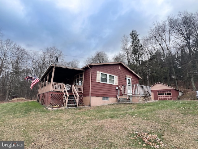 rear view of house featuring a lawn, an outdoor structure, and a garage