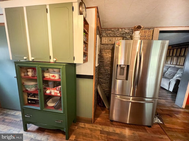 kitchen featuring dark hardwood / wood-style floors, stainless steel fridge, and green cabinetry