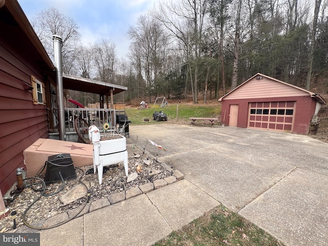 view of patio / terrace with a garage and an outdoor structure